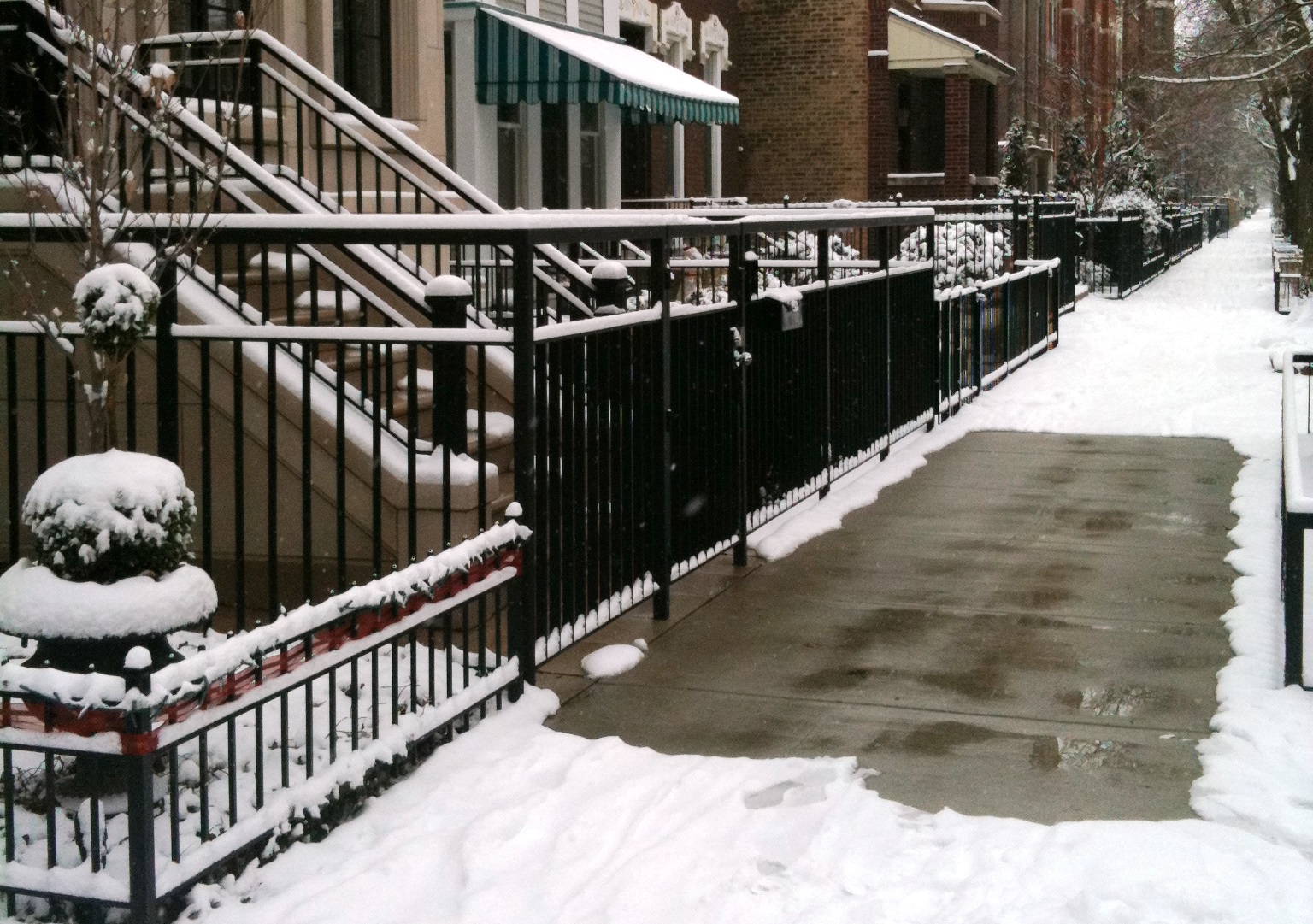 melted path area on snowy sidewalk