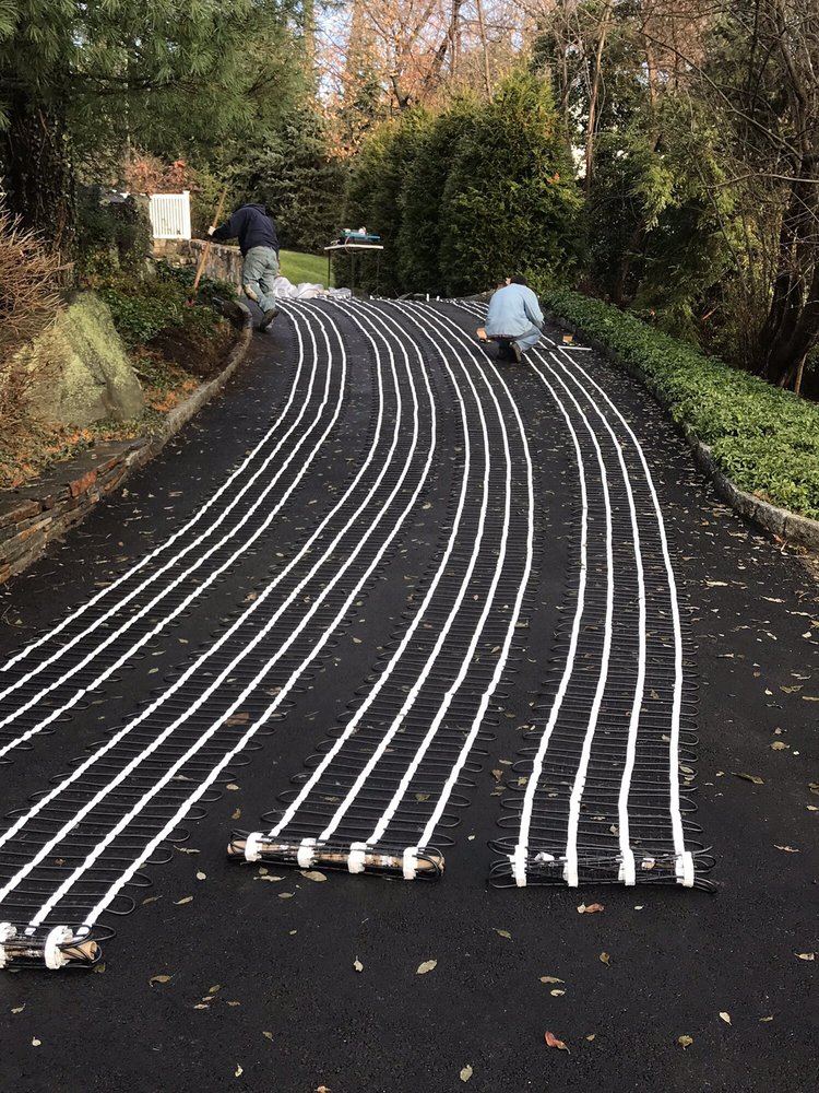 snowmelting cable mat being installed in driveway